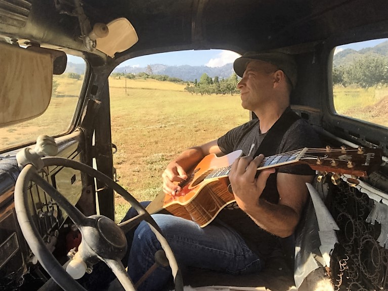 billy with a guitar in a truck